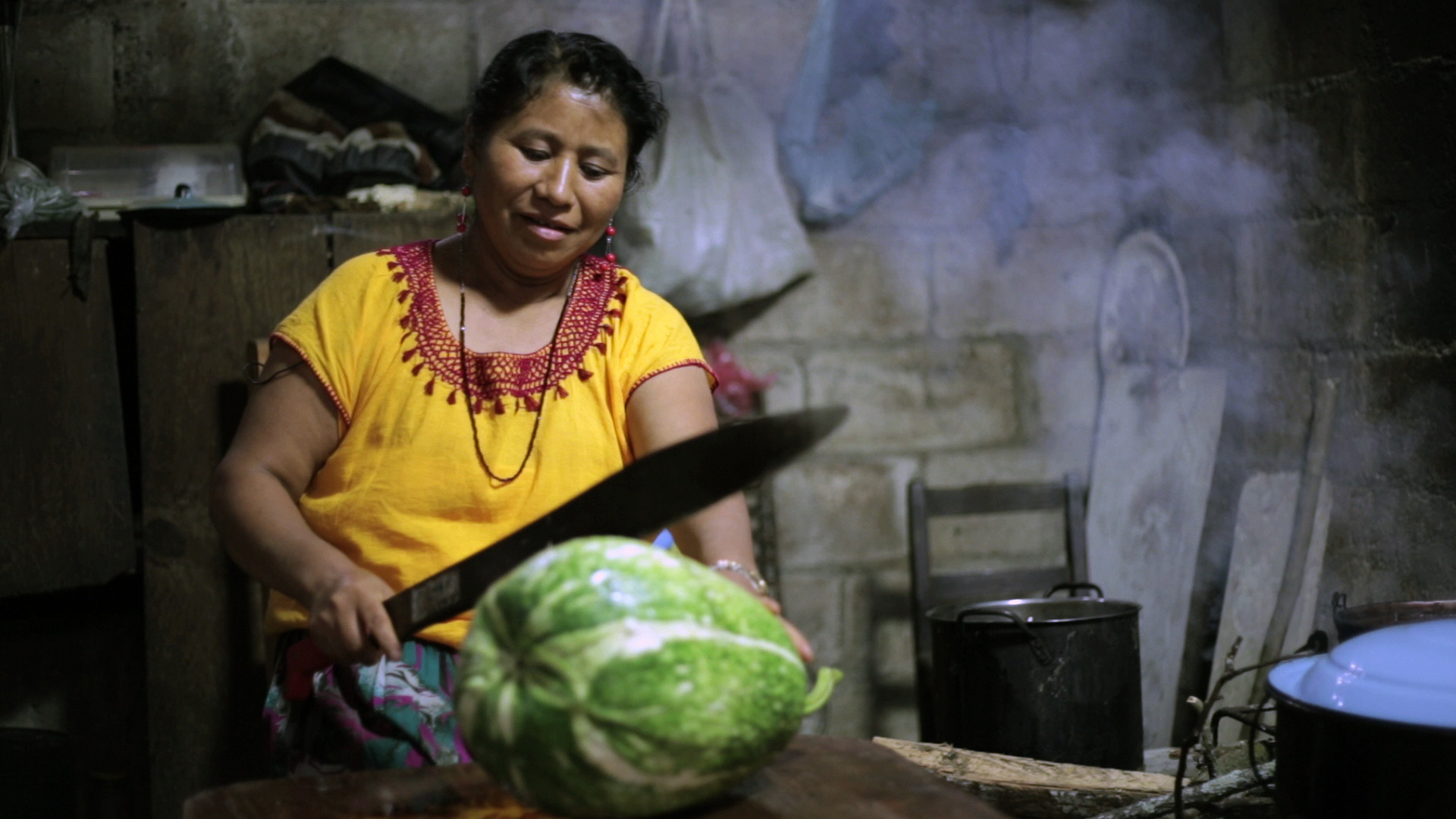Photo of mother cutting a melon