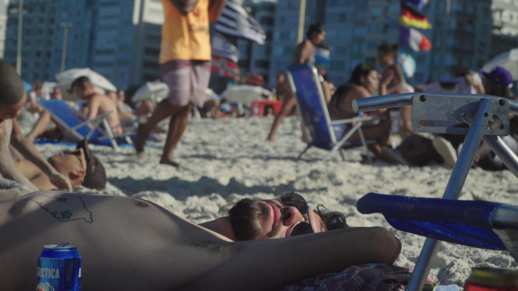 Man lying on crowded beach