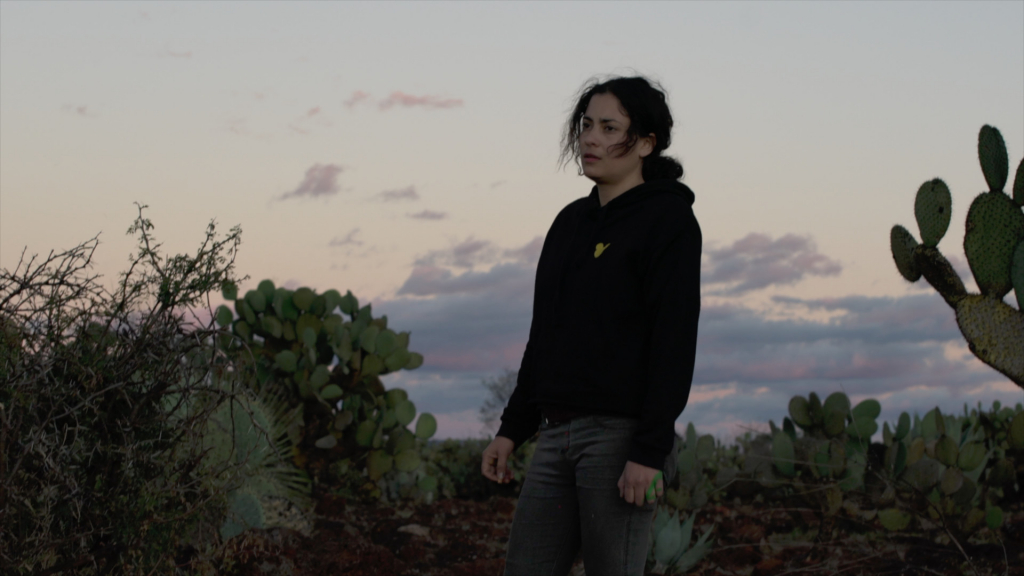 Paty Aguirre standing in the desert at sunset