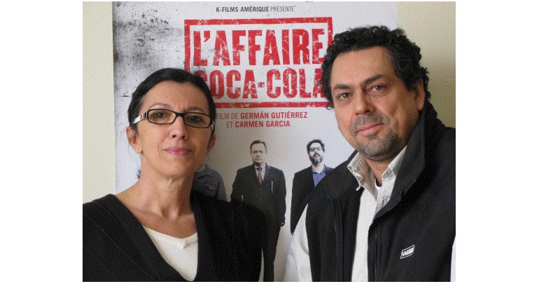 Carmen García & Germán Gutiérrez in front of film poster